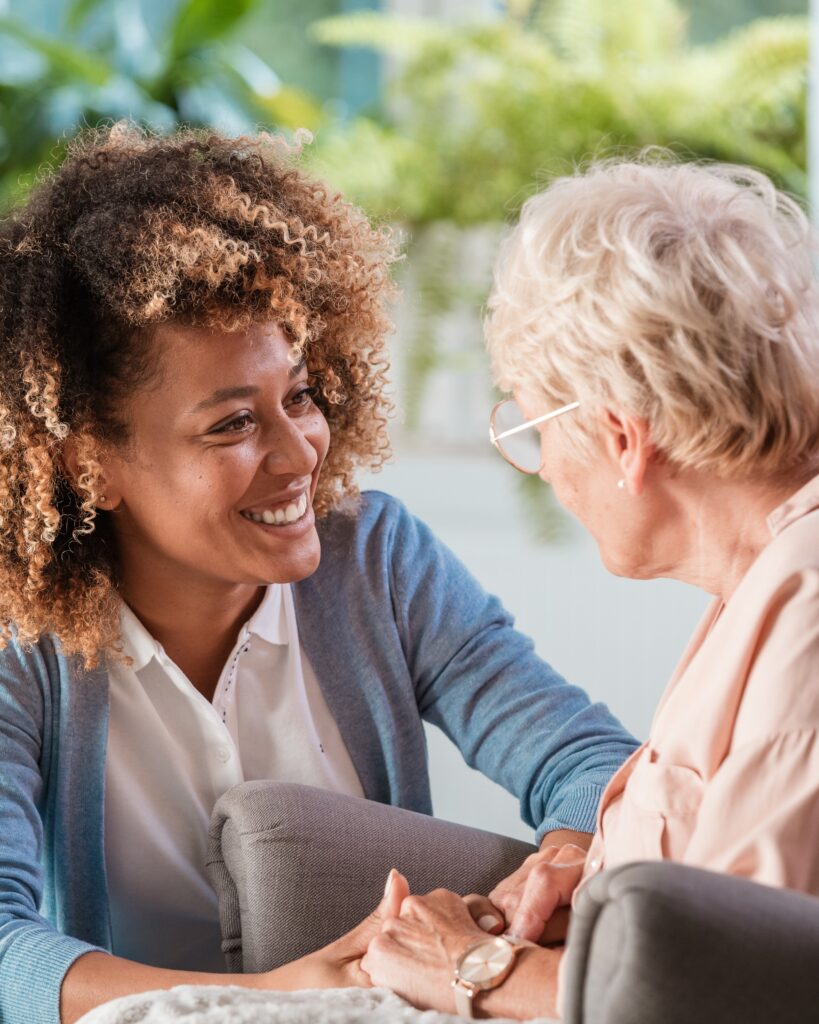 Home caregiver taking care of elderly woman